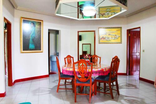 a dining room with a table and chairs at Erema Village in Bogor
