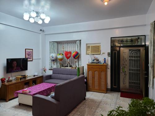 a living room with a couch and a table at Fire B&B in Chishang