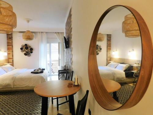 a room with two beds and a mirror at Brand New Studio 3 in Komotini