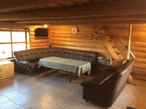 a living room with a leather couch and a table at Tatra Holiday House in Tatra