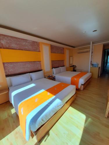 Postel nebo postele na pokoji v ubytování 墾丁大街 皇佳旅店