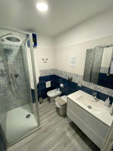 a bathroom with a shower and a sink and a toilet at La CasAffittiera Apartments Group in Anzio