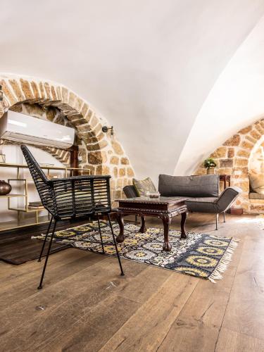 a living room with a chair and a table at Flora Valley Boutique Hotel in Jerusalem