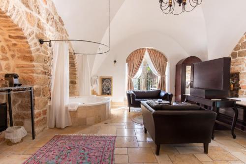a living room with a fireplace and a bath tub at Flora Valley Boutique Hotel in Jerusalem