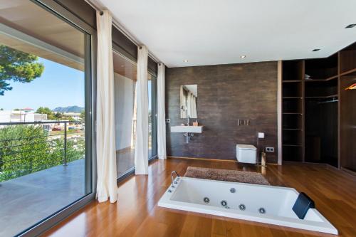 a bathroom with a large tub in the middle of a room at 206 Villa Isabel ET2341 by Mallorca Charme in Alcudia