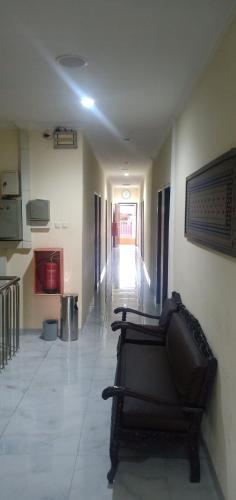 a hallway with a couch in the middle of a room at Citra Hotel in Palembang