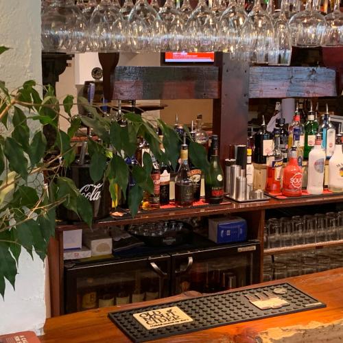 a bar with a lot of bottles of alcohol at Churchills Inn & Rooms in Bowness-on-Windermere
