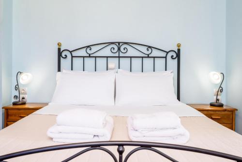 a bedroom with a bed with white towels on it at Villa Ostria in Georgioupolis