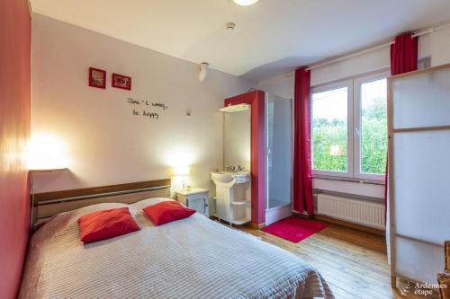 a bedroom with a bed and a sink and a window at Les Bastinettes in Stoumont