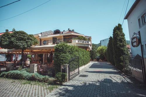 a building with a fence next to a street at Provence rooms in Banja Luka