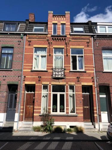 a red brick building with windows and a balcony at inn Venlo Apartment in Venlo