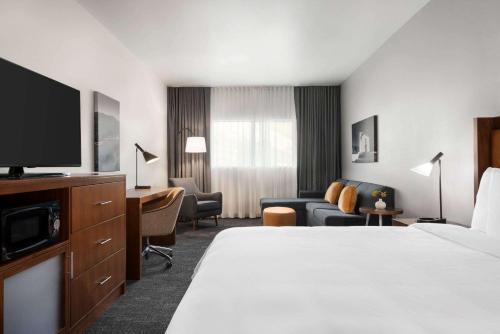 a hotel room with a bed and a tv at La Quinta by Wyndham San Luis Obispo in San Luis Obispo