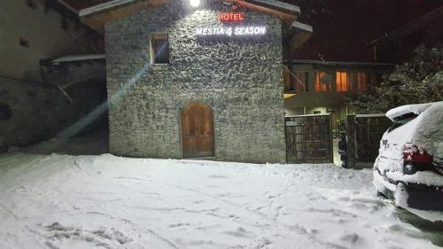 a building with a door in the snow at Mestia 4 season in Mestia