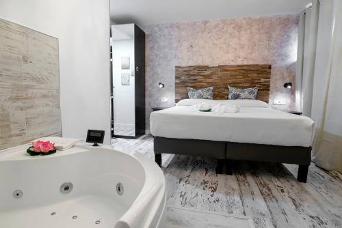a bedroom with a large bed and a bath tub at Habitaciones Premium Finca la Casona in San Rafael