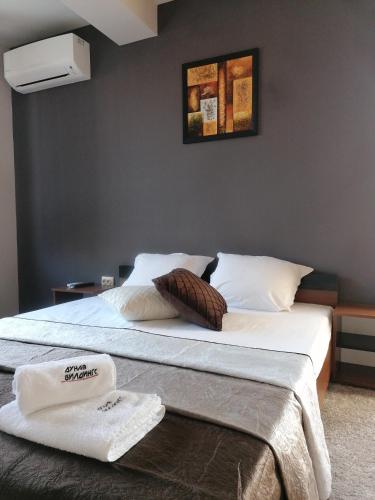 a bedroom with a bed with two towels on it at Дунав билдингс in Pleven