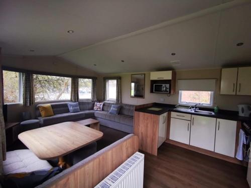a kitchen and living room with a couch and a table at 67 Newquay Getaway in Porth