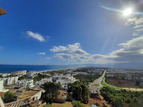 a view of a city with the ocean in the background at Bella Vista Cabo Negro-vue sur mer in Cabo Negro
