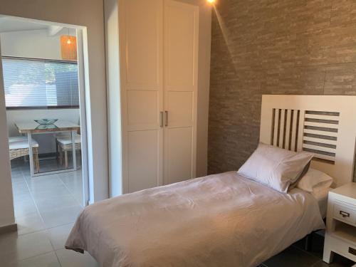 a bedroom with a bed and a dining room with a table at Apartamentos Finca Wapa in Frontera