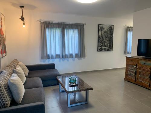 a living room with a couch and a coffee table at Apartamentos Finca Wapa in Frontera