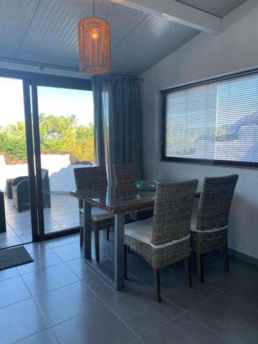 a dining room with a glass table and chairs at Apartamentos Finca Wapa in Frontera