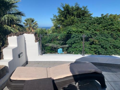 a bench sitting on top of a patio at Apartamentos Finca Wapa in Frontera
