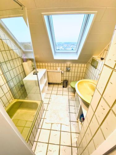 a bathroom with a sink and a window at Ferienwohnung im schönen Westerwald in Müschenbach