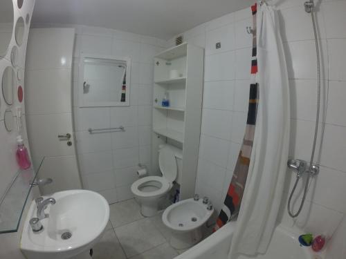 a bathroom with a sink and a toilet and a shower at Torre Angel - Fragueiro 325 in Córdoba