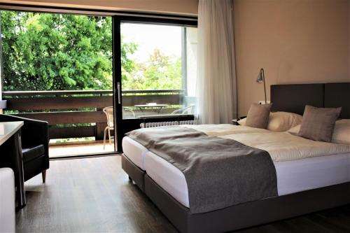 Postel nebo postele na pokoji v ubytování Hotel garni Bellevue