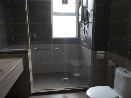 a bathroom with a shower and a toilet and a sink at Goodview Vacation Homestay @Kajang in Kajang