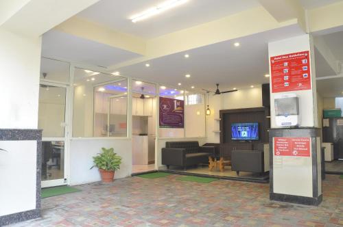 a lobby with a waiting area with a tv in it at JK Rooms 126 Parashar Legacy - Opp Railway Station in Nagpur