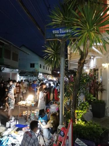 a crowd of people at an outdoor market at night at Rynn in Trat