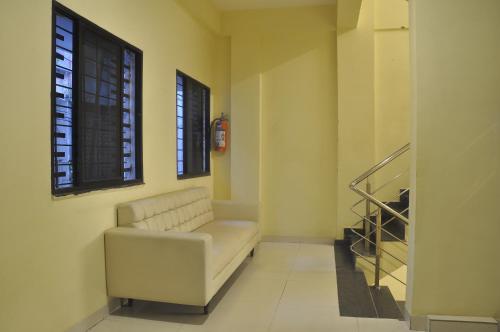 a living room with a white couch and a window at JK Rooms 126 Parashar Legacy - Opp Railway Station in Nagpur