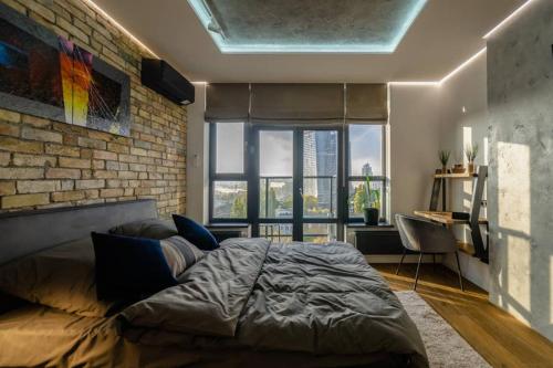 a bedroom with a bed and a brick wall at VIP - Smart in Kyiv