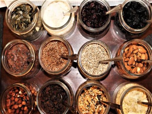 a group of jars filled with different types of nuts at Hotel garni Bellevue in Bad Füssing