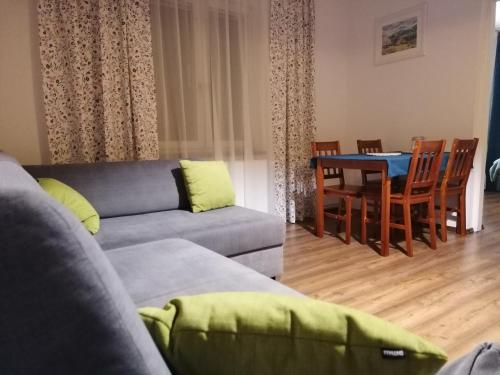 a living room with a couch and a table at Leśniczówka Kalina in Wetlina