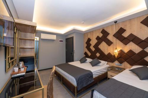 a hotel room with two beds and a staircase at Fly And Stay Airport Hotel in Istanbul