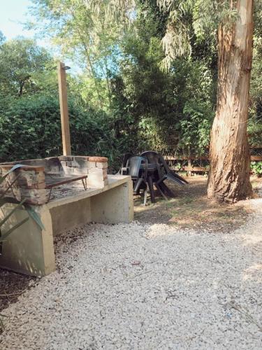 a picnic table and a bench in a park at Cabañas Aire Fresco in Mar del Plata