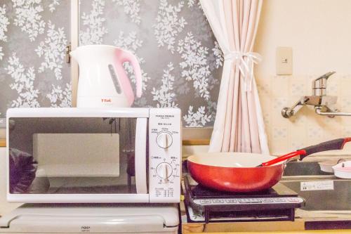 TV a/nebo společenská místnost v ubytování The Familiar Inn ー 旅館ホテル業