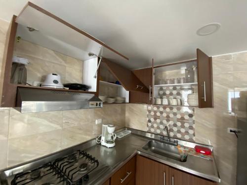 a kitchen with a sink and a stove top oven at Apartamento Amoblado en Cartagena de Indias in Cartagena de Indias