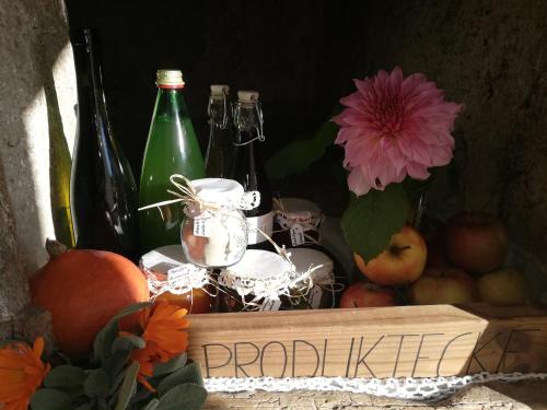 a picture of a table with wine bottles and flowers at Ansitz Grustdorf in Appiano sulla Strada del Vino