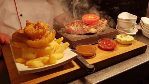 a plate of food with onion rings and a sandwich at Balreask Bar, Restaurant & Guest Accommodation in Navan