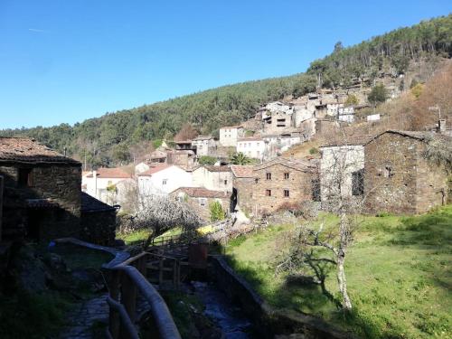 a small village on a hill with buildings at Casa das Tias in Lousã