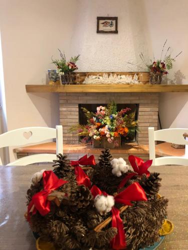 a christmas centerpiece on a table with a fireplace at Il Bosco Guest House Subiaco in Subiaco
