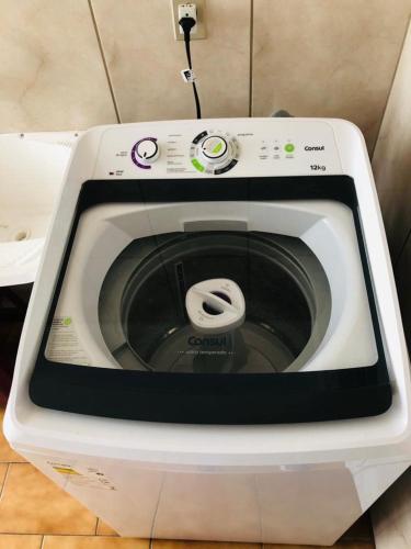 a washing machine with its door open in a kitchen at Apto 2D Centro in Santa Cruz do Sul