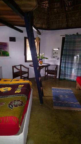 Un dormitorio con 2 camas y una mesa en una habitación en Castillo Oasis, en Zipolite