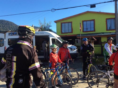 a group of people standing next to their bikes at Hostal Scarlett in Puerto Puyuhuapi