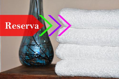 a stack of towels on a table next to a vase at Tlaquepaque Pueblito in Guadalajara