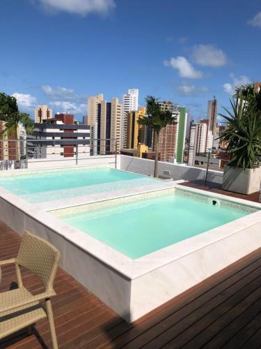 a swimming pool on the roof of a building at Manaíra Apart Hotel - Flat 201 in João Pessoa
