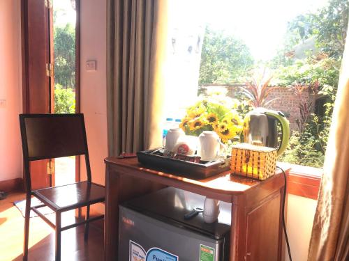 a room with a table and a chair and a window at Tam Coc Friendly Homestay in Ninh Binh