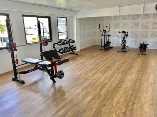 a gym with several treadmills and machines in a room at Diamond de pai in Pai